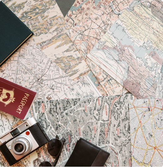 Camera, passports and maps laid out on a table